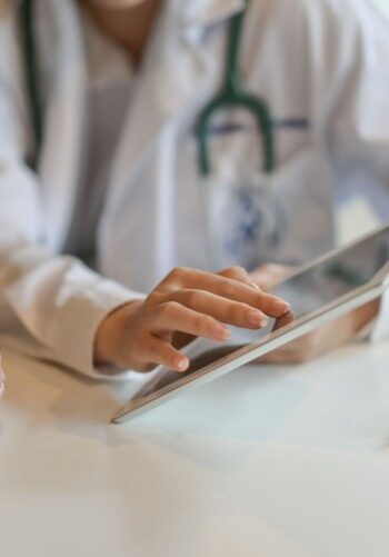 Shot of a doctor showing a patient some information on a digital tablet